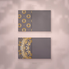 Business card in brown color with a luxurious gold pattern for your contacts.