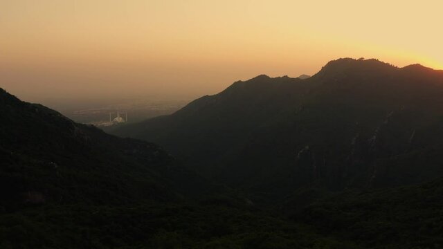 Aerial view of sunset with beautiful colors over the silhouette of margalla hills in Islamabad, Pakistan