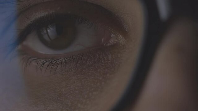 Closeup macro man's eye focused on the screen, working, reading, surfing