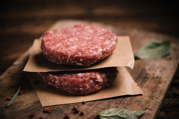 Burger steak cutlets ready to prepare on rustic table