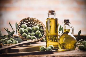 Olive oil with fresh olives on rustic wood - 466020790