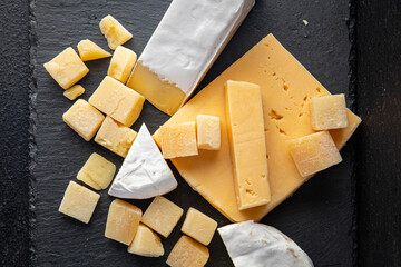 cheese plate assorted cheeses aperitif antipasto brie, camembert, cheddar, parmesan and others ready to eat meal snack on the table copy space food background rustic. top view