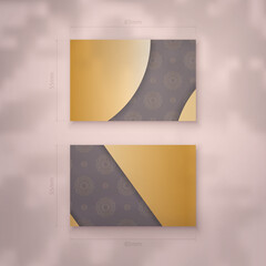 Brown business card with Greek gold pattern for your business.