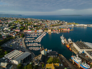 Beautiful aerial view of the City of Torshavn Capital of Faroe Islands- View of Cathedral, colorful buildings, marina, suburbs and Flag