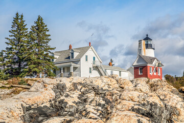 Fototapeta na wymiar The landmark Pemaquid Point Lighthouse sits atop the rocky Atlantic Ocean coast near Bristol, Lincoln County, Maine.