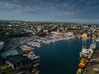 Beautiful aerial view of the City of Torshavn Capital of Faroe Islands- View of Cathedral, colorful buildings, marina, suburbs and Flag