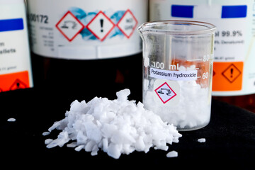 Potassium hydroxide flake on black background