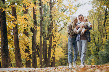 Fototapeta premium Young family with little daughter in autumn park