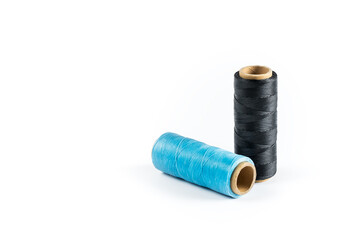 Coils of colored threads on a white background. Waxed sewing thread for leather crafts.