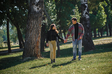 Fototapeta premium Cheerful and romantic couple in love, walk together in nature