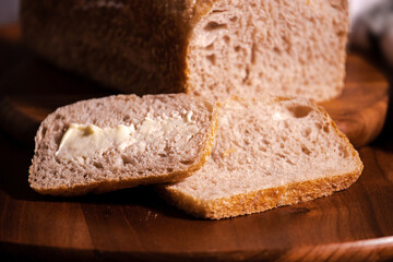 Bakery - sliced whole grain bread with butter. Healthy food.