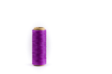 A coil of purple thread. Spool of colored threads on a white background. Waxed sewing thread for leather crafts.
