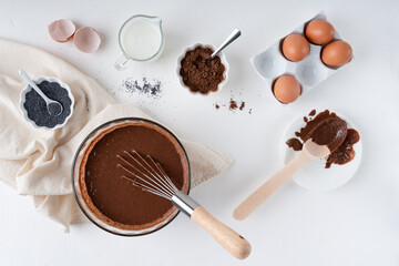 Cooking chocolate dough. Pie. Cake ingredients. White background. On the kitchen