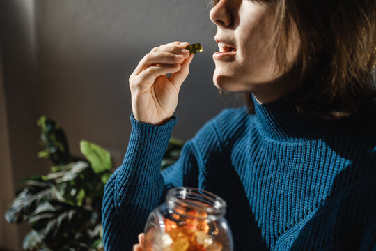 Cbd cannabis gummy - Woman eating edible weed sweet candy leaf for anxiety alternative treatment - Medical marijuana