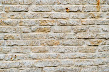 Obraz premium Magnificent old limestone brick wall. Can be used as background or pattern for other projects