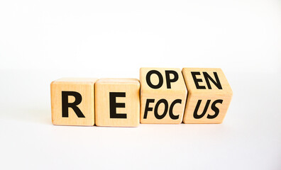 Refocus and reopen symbol. Businessman turned cubes and changed the word 'refocus' to 'reopen'....