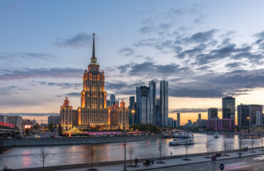 Illuminated Royal Hotel Radisson near river at evening in Moscow, Russia. Historic name is Hotel Ukraina.