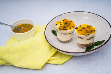 passion fruit dessert with a yellow cloth on a marble background