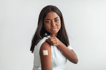 Happy Vaccinated Woman With Adhesive Bandage On Shoulder