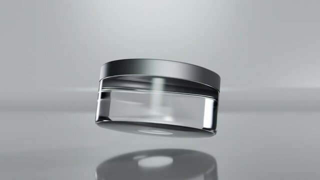 loop animation of Glass cosmetic empty jar, lotion packaging,  Bottle rotates slowly in air. Women's cosmetics skincare. Sample of layout of package beauty product. Luma matte, Realistic 3d render.