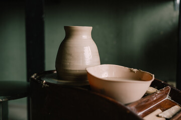 Pottery jugs and cups made of natural clay. Pottery master's workshop. concept is a manual hobby.