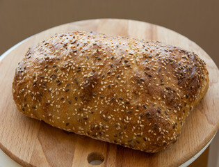 bread sprinkled with seeds on a wooden board
