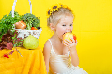 Fototapeta na wymiar Beautiful little happy girl with basket vegetables and fruits