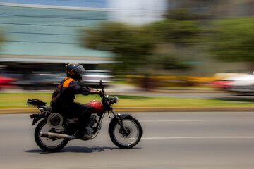 Obraz na płótnie Canvas Motorcyclist going fast in the city