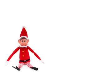 Christmas Elf toy on an isolated white background with copy space. Christmas spirit, Christmas shelf tradition. - obrazy, fototapety, plakaty