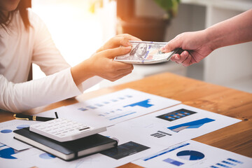 businessman or accountant who are using a calculator to calculate business data Accounting documents and laptop computer at the office business idea