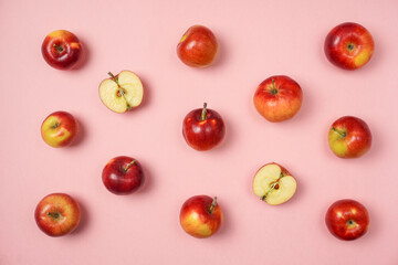Colorful fruit pattern of fresh red apples on pink background. Flat lay, top view, copy space for your text. Healthy concept