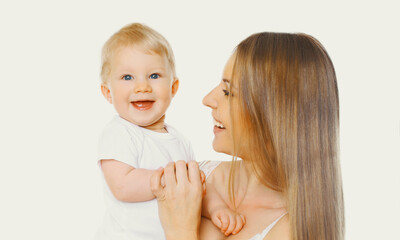 Portrait of happy cheerful smiling mother and baby playing together on a white background