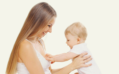 Portrait of happy cheerful smiling mother and baby playing together on a white background