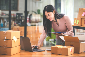 Small start-up business owners checking parcels at work, freelancers, salespeople, checking...