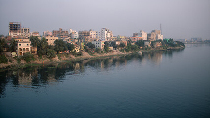 Fototapeta na wymiar Picture of one side of Dhaka city on the banks of river Buriganga.The river Buriganga has enhanced the beauty of the capital city Dhaka.