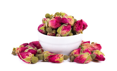 Heap of dry tea roses buds in ceramic bowl, isolated on white background. Rose flower tea. Clipping path.