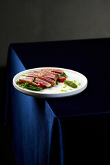 Slices of tuna ahi with fresh vegetable salad on a plate. 