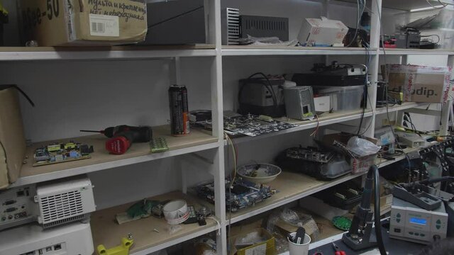 Engineer repairs electronics. Service man. Hardware reparing. Service room..