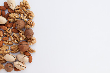different types of nuts on a white background with space for text
