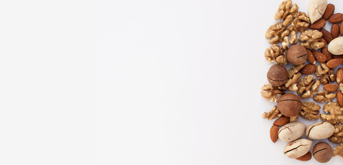 different types of nuts on a white background with a place for the text in the form of a banner