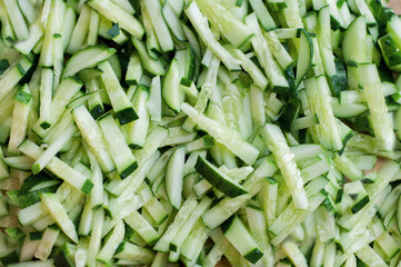 Finely chopped fresh cucumbers in strips with a solid background