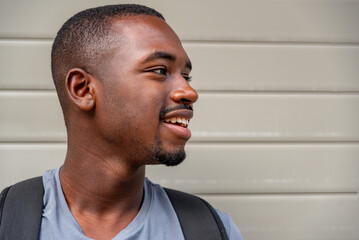 Fototapeta premium Portrait of afro young man smiling outdoors