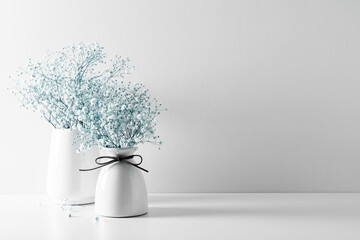 Elegant floral soft white composition, white flowers. Beautiful white gypsophila flower in vase on...