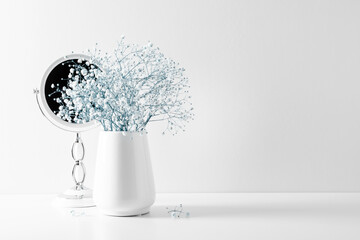 Elegant floral soft white composition, mirror, white flowers. Beautiful white gypsophila flower in...
