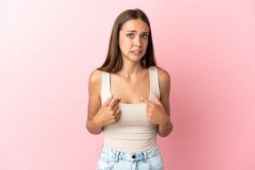 Young woman over isolated pink background pointing to oneself