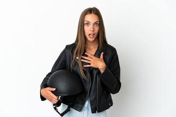 Woman with a motorcycle helmet over isolated white background surprised and shocked while looking right