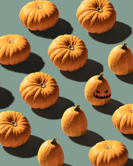 Pumpkins patterned over blue background with evil laughing pumpkin