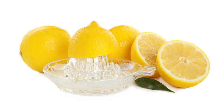 Plastic juicer and fresh lemons on white background