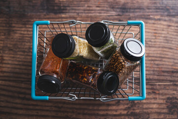 spices and seasonings in matching spice jars in ngrocery shopping basket, simple vegan ingredients and flavoring your dishes