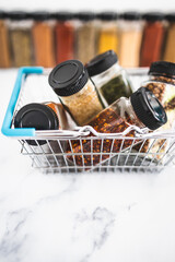 spices and seasonings in matching spice jars in ngrocery shopping basket, simple vegan ingredients and flavoring your dishes